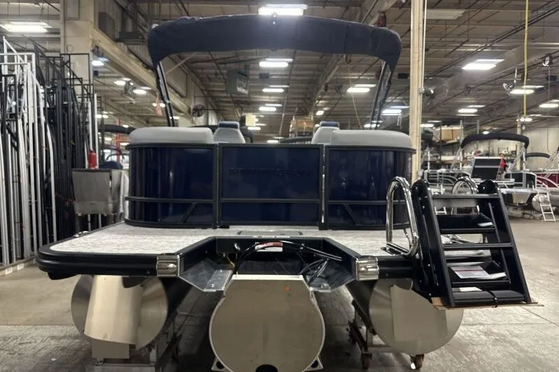 Slide: The Image of 2026 Bennington 23 SSRSF pontoon boat in a warehouse setting, rear view. - 7