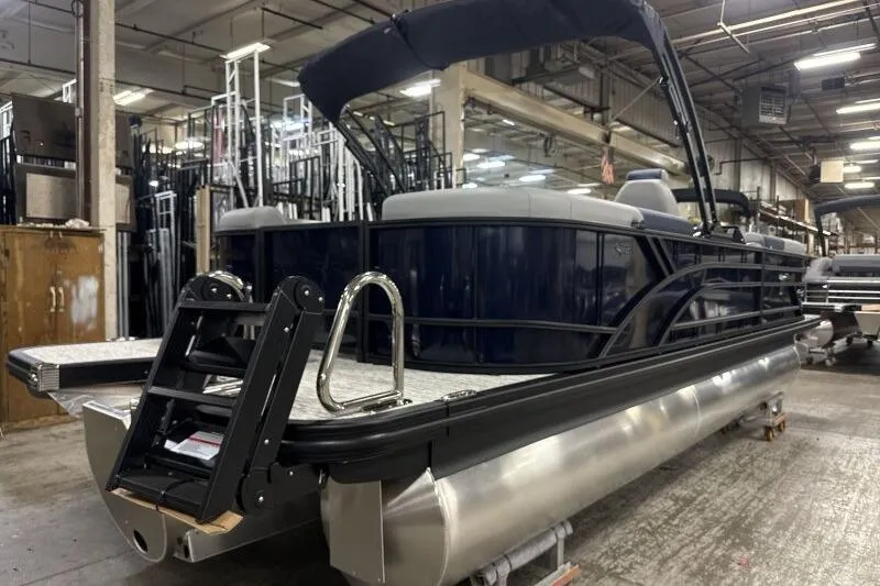 Slide: The Image of 2026 Bennington 23 SSRSF pontoon boat in a warehouse setting. - 8