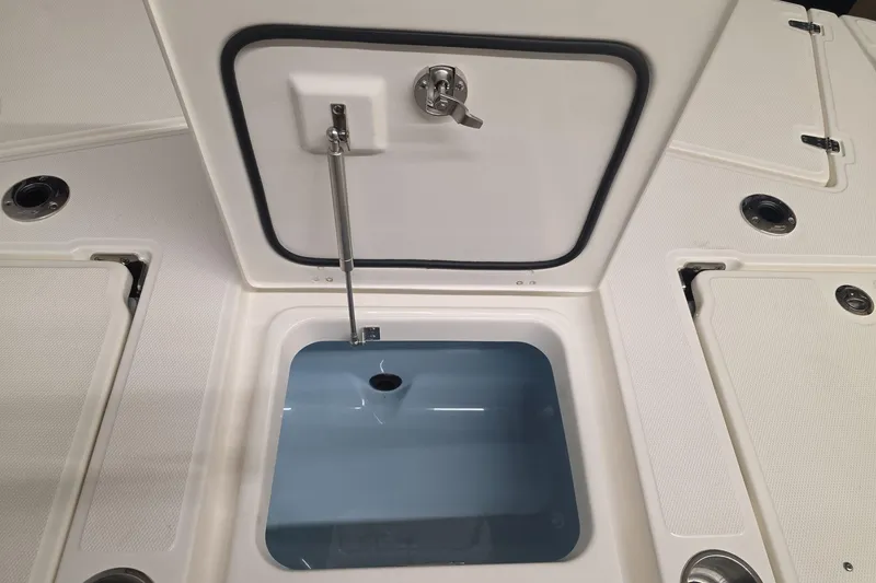 Slide: The Image of 2026 Boston Whaler 250 Dauntless boat storage compartment with open hatch. - 13