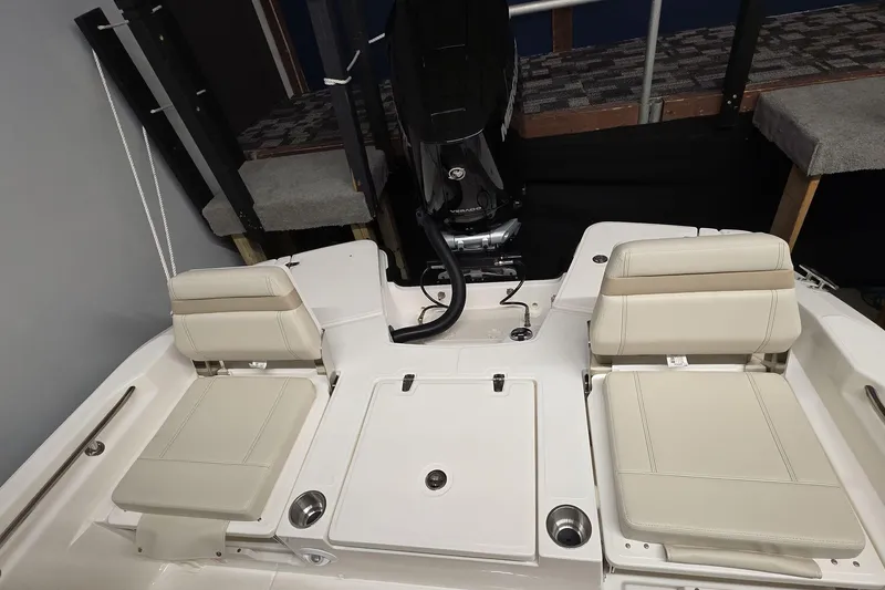 Slide: The Image of 2026 Boston Whaler 250 Dauntless boat interior with seating and engine view. - 14