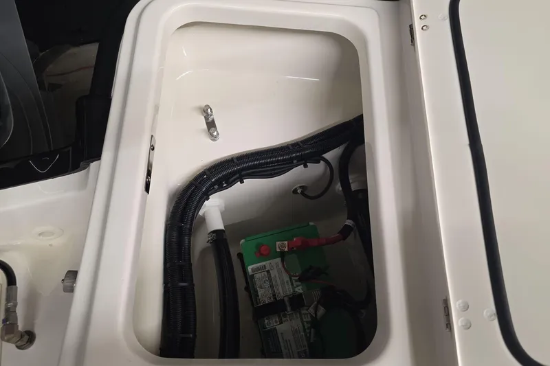 Slide: The Image of 2026 Boston Whaler 250 Dauntless battery compartment with wiring and components. - 15