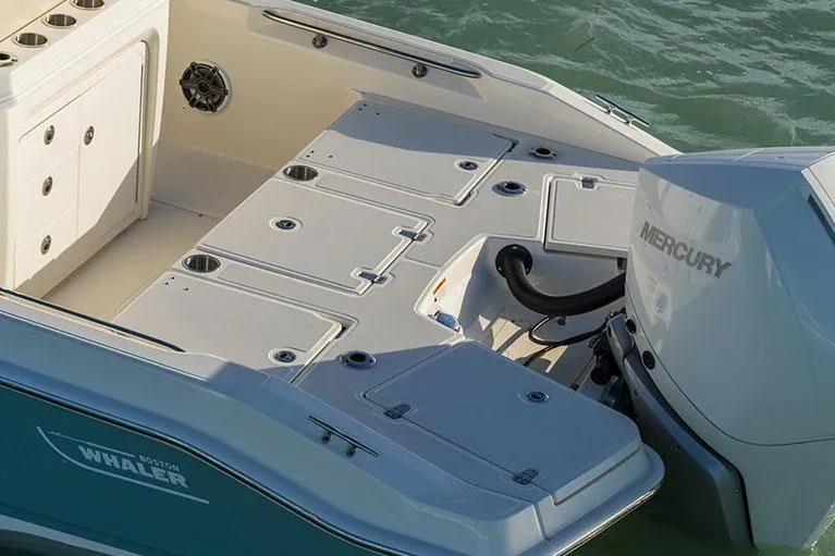 Slide: The Image of Manufacturer Provided Image: 2026 Boston Whaler 250 Dauntless boat deck with Mercury engine in water. - 8