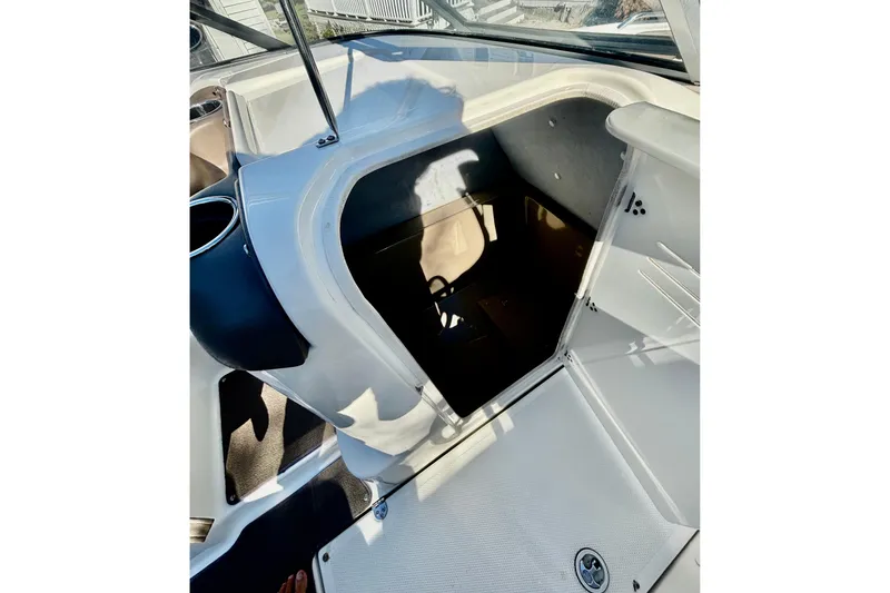 Slide: The Image of 2012 Yamaha Boats AR240 HO interior storage compartment with open hatch. - 11