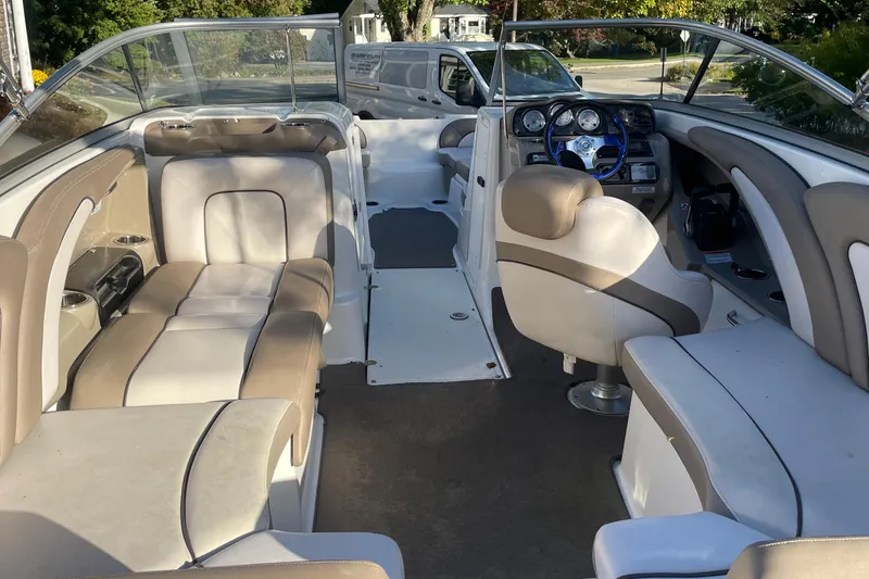 Slide: The Image of 2012 Yamaha Boats AR240 HO interior with beige seating and modern dashboard. - 6