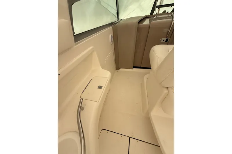 Slide: The Image of Interior view of 2000 Sea Ray 310 Sundancer boat, featuring beige seating and dashboard. - 10