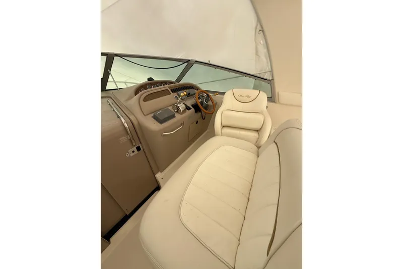 Slide: The Image of Interior of 2000 Sea Ray 310 Sundancer boat with beige seating and helm. - 11