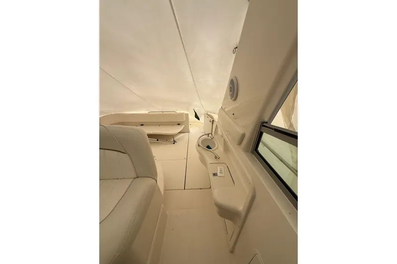 Slide: The Image of Interior of 2000 Sea Ray 310 Sundancer boat, featuring seating and storage areas. - 16