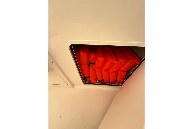 Slide: The Image of Life jackets stored in a compartment on a 2000 Sea Ray 310 Sundancer boat. - 17