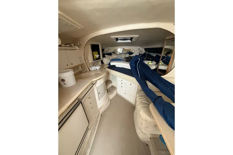 Slide: The Image of Interior of 2000 Sea Ray 310 Sundancer yacht with kitchenette and sleeping area. - 18