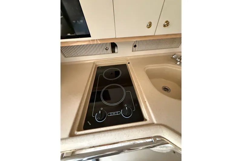 Slide: The Image of 2000 Sea Ray 310 Sundancer kitchen with stovetop and sink. - 20