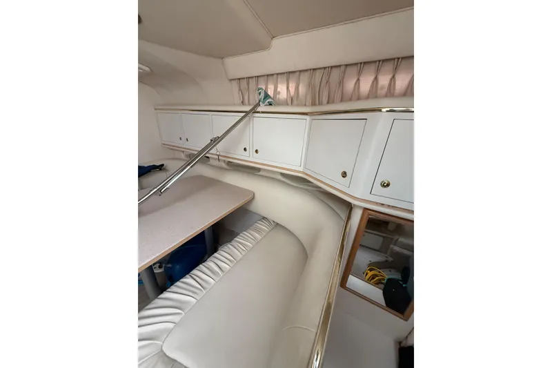 Slide: The Image of Interior of 2000 Sea Ray 310 Sundancer with white seating and cabinetry. - 22