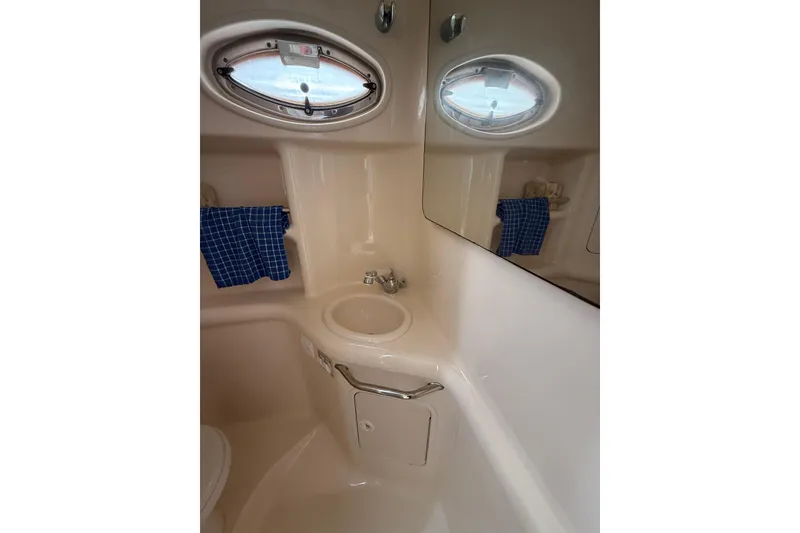 Slide: The Image of Bathroom interior of 2000 Sea Ray 310 Sundancer yacht with sink and porthole. - 26