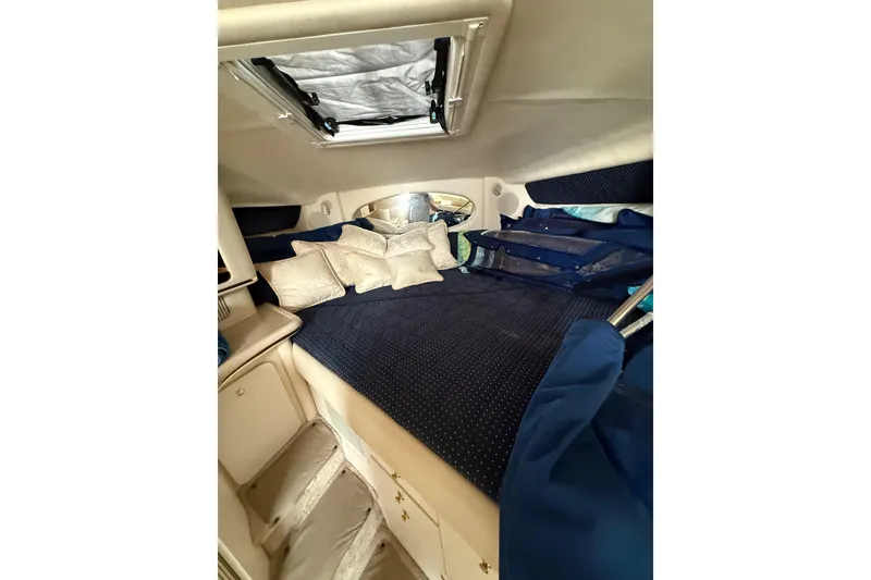 Slide: The Image of Interior cabin of 2000 Sea Ray 310 Sundancer with cozy bedding and skylight. - 31