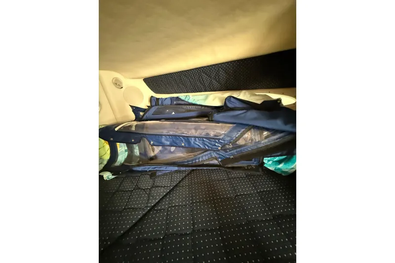 Slide: The Image of Interior cabin of 2000 Sea Ray 310 Sundancer with folded blue cover. - 33