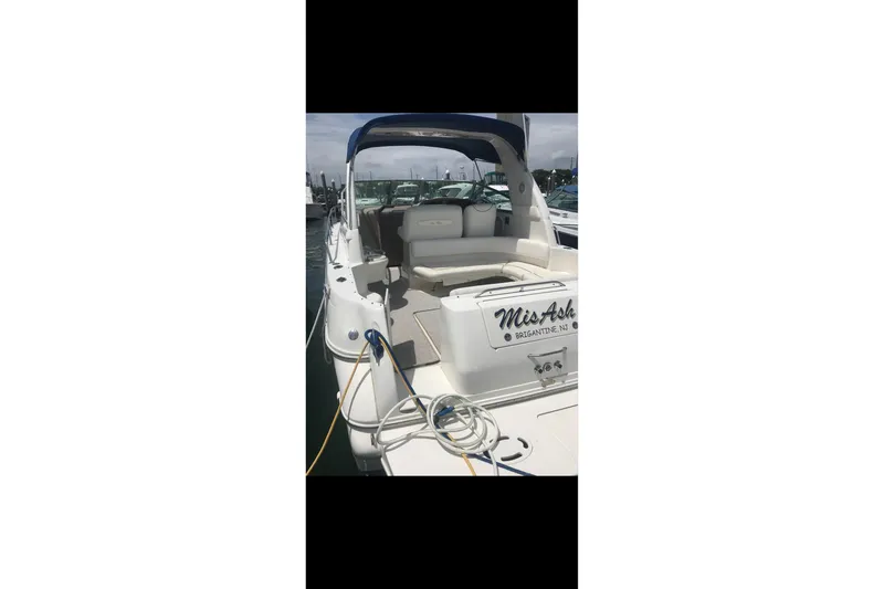 Slide: The Image of 2000 Sea Ray 310 Sundancer boat with seating area, docked at marina. - 5