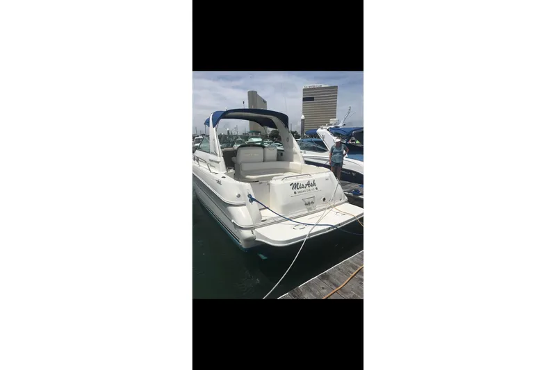 Slide: The Image of 2000 Sea Ray 310 Sundancer docked at marina, rear view. - 7