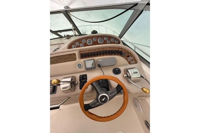 Slide: The Image of Cockpit of 2000 Sea Ray 310 Sundancer with steering wheel and control panel. - 8