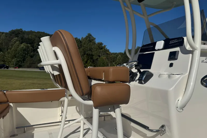 Slide: The Image of 2026 Pioneer 222 Islander boat interior with brown seating and modern dashboard. - 10