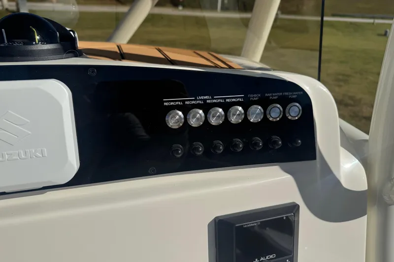 Slide: The Image of Control panel of 2026 Pioneer 222 Islander boat with various switches and buttons. - 15