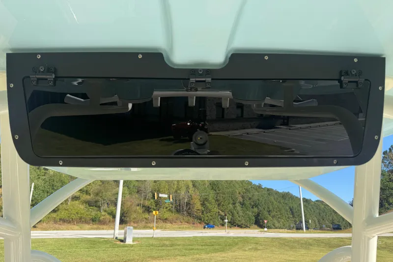 Slide: The Image of 2026 Pioneer 222 Islander boat console with black panel and scenic background. - 19