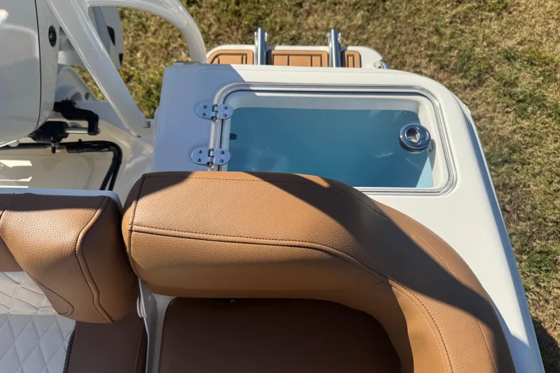 Slide: The Image of 2026 Pioneer 222 Islander boat with tan seating and a built-in storage compartment. - 24
