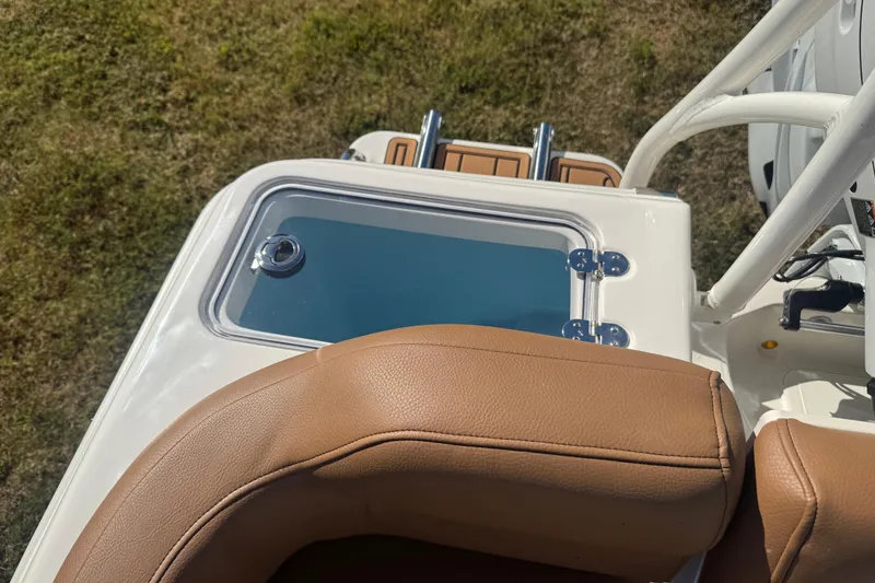 Slide: The Image of 2026 Pioneer 222 Islander boat interior with tan seating and livewell. - 25