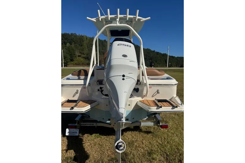 Slide: The Image of 2026 Pioneer 222 Islander boat with powerful outboard motor, displayed on grass. - 32