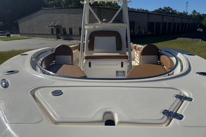 Slide: The Image of 2026 Pioneer 222 Islander boat interior with cushioned seating and storage compartments. - 6