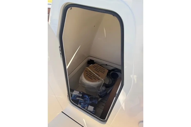 Slide: The Image of Storage compartment of 2026 Pioneer 222 Islander boat with various items inside. - 9