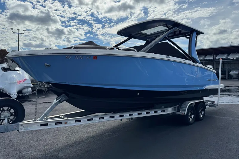 Slide: The Image of 2024 Chaparral 280 OSX boat on trailer under cloudy sky. - 1