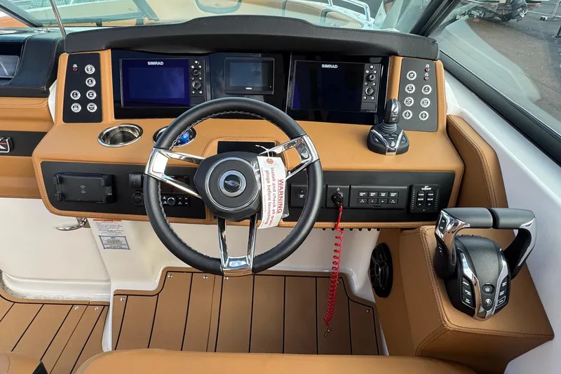 Slide: The Image of 2024 Chaparral 280 OSX helm with modern controls and Simrad displays. - 11