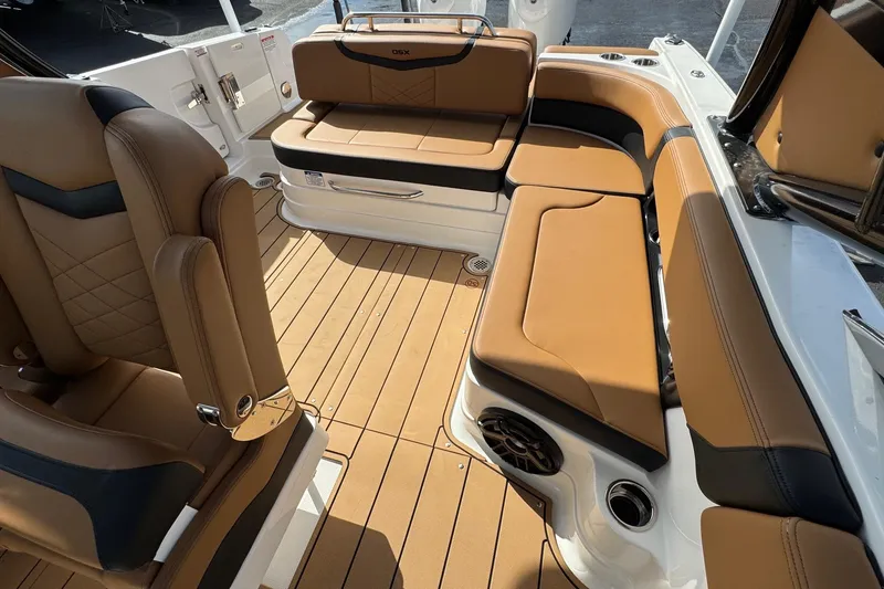 Slide: The Image of 2024 Chaparral 280 OSX boat interior with tan leather seating and teak flooring. - 14