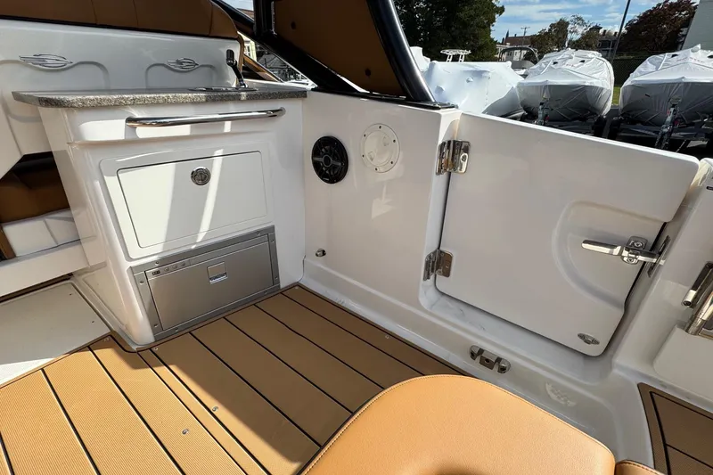 Slide: The Image of 2024 Chaparral 280 OSX boat interior with sleek cabinetry and modern design. - 17