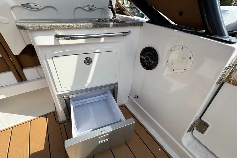 Slide: The Image of 2024 Chaparral 280 OSX boat interior with open drawer and countertop. - 20
