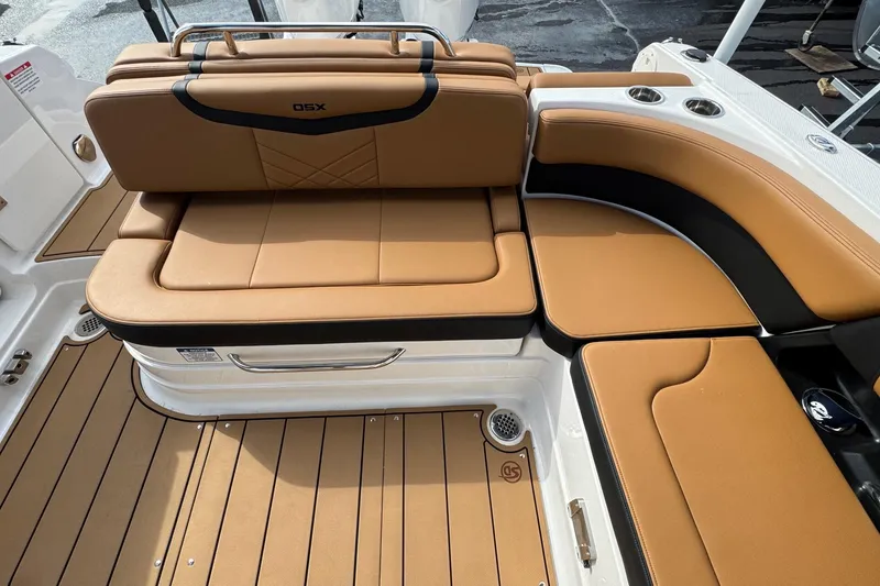 Slide: The Image of 2024 Chaparral 280 OSX boat interior with tan leather seating and teak flooring. - 21