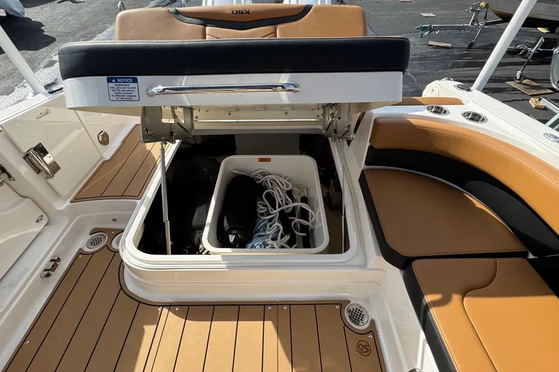 Slide: The Image of 2024 Chaparral 280 OSX boat storage compartment with ropes and accessories. - 22
