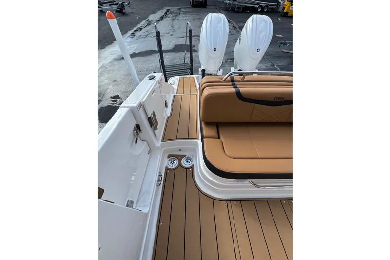 Slide: The Image of 2024 Chaparral 280 OSX boat with tan seating and dual outboard engines. - 24