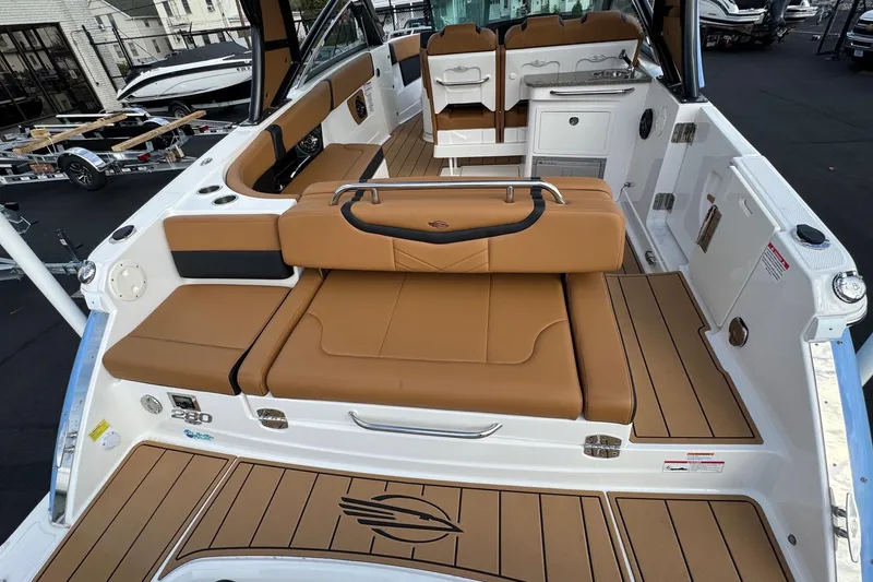 Slide: The Image of 2024 Chaparral 280 OSX boat interior with tan seating and sleek design. - 25