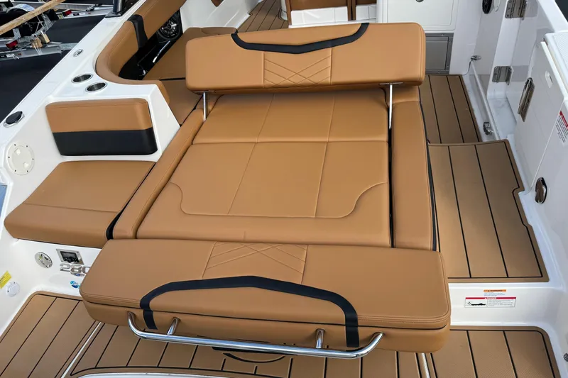 Slide: The Image of 2024 Chaparral 280 OSX boat interior with tan leather seating and sleek design. - 26