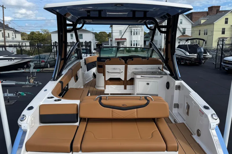 Slide: The Image of 2024 Chaparral 280 OSX boat interior with tan seating and modern design. - 27