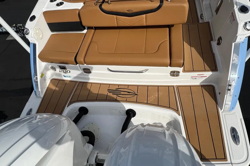 Slide: The Image of 2024 Chaparral 280 OSX boat with tan seating and sleek deck design. - 28