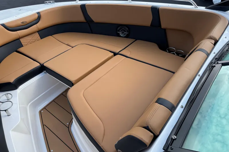 Slide: The Image of 2024 Chaparral 280 OSX boat interior with tan and black cushioned seating. - 4