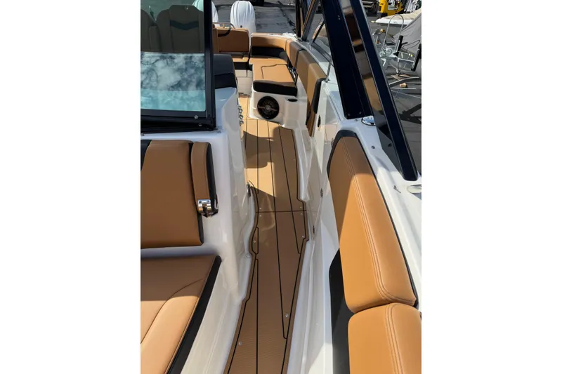 Slide: The Image of 2024 Chaparral 280 OSX boat interior with tan seating and sleek design. - 7