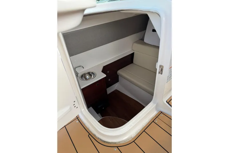 Slide: The Image of 2024 Chaparral 280 OSX cabin interior with seating and sink, featuring modern design elements. - 9
