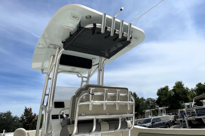 Slide: The Image of 2024 Key West 239 FS boat with T-top and rod holders under clear sky. - 13