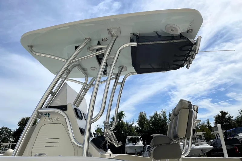 Slide: The Image of 2024 Key West 239 FS boat with T-top and seating, under a clear sky. - 14