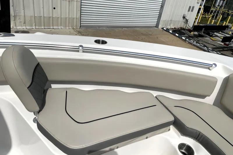Slide: The Image of 2024 Key West 239 FS boat interior with cushioned seating and stainless steel rail. - 17
