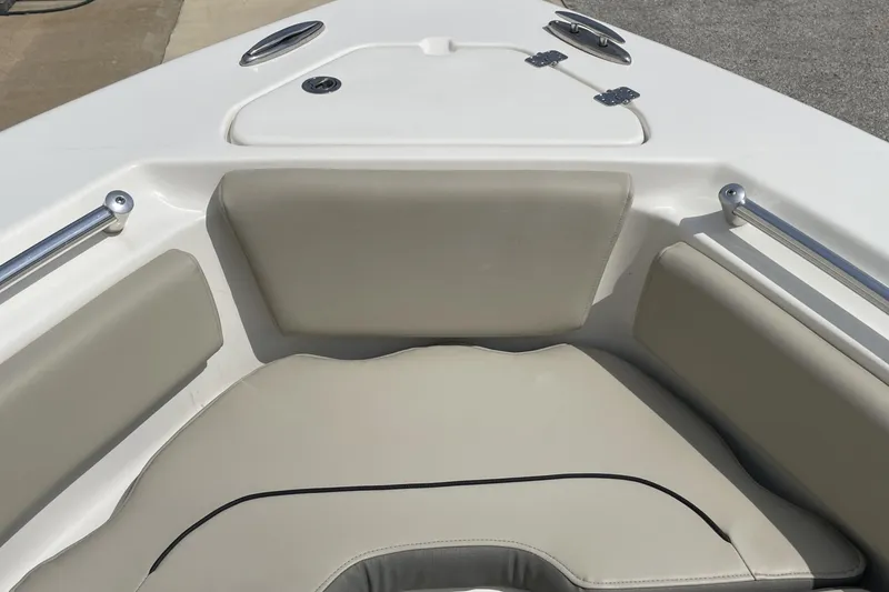 Slide: The Image of 2024 Key West 239 FS boat interior with cushioned seating and stainless steel rails. - 18
