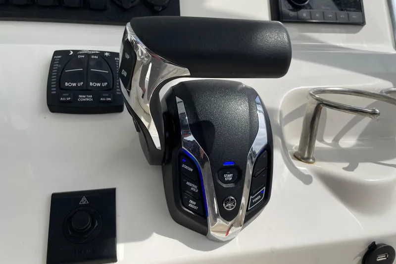 Slide: The Image of 2024 Key West 239 FS boat controls with trim tab and throttle levers. - 27