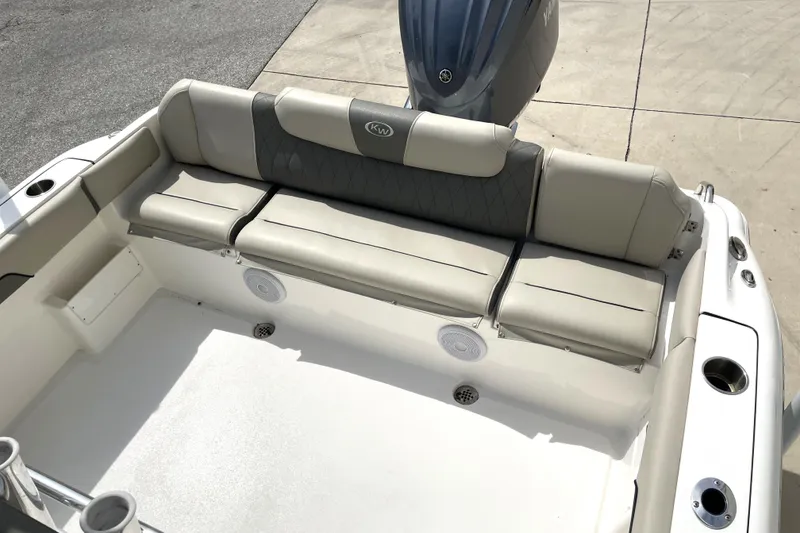 Slide: The Image of 2024 Key West 239 FS boat interior with cushioned seating and motor. - 29